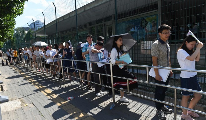 People lining up for visa interviews in front of the U.S. Embassy in Beijing. Image Credit: AFP