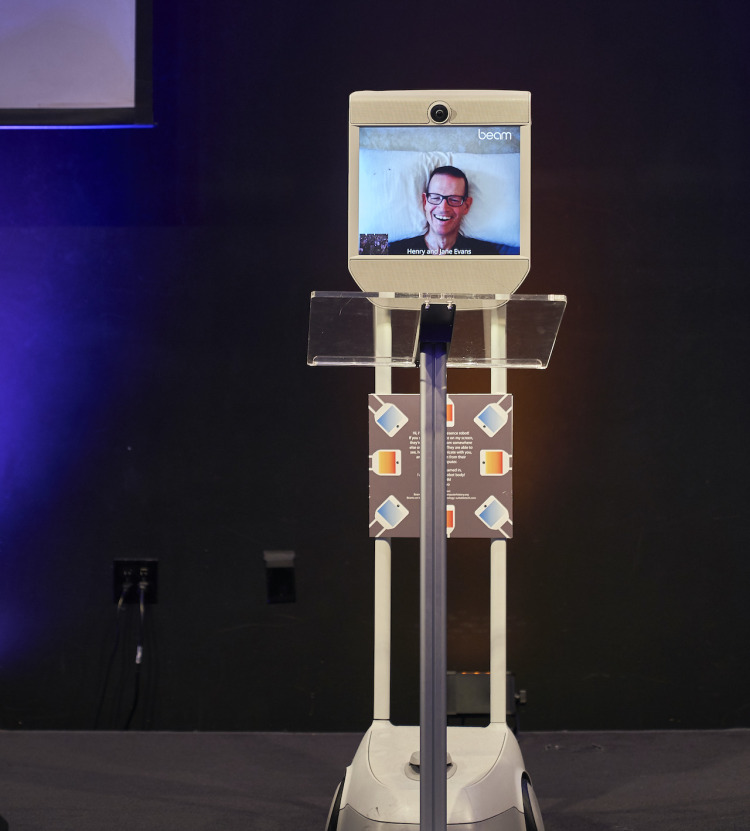 Henry Evans, Co-founder at Robots for Humanity joins the SYNC 2019 event remotely through a telepresence robot.