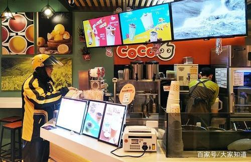 A Meituan Courier Picking Up Food at A Restaurant