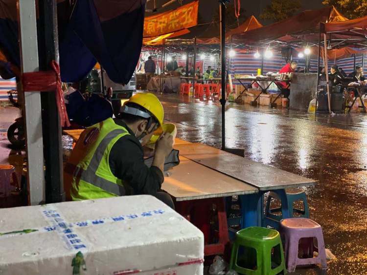 A Tesla worker finishing his meal at the street food stalls outside the Shanghai Gigafactory 3.