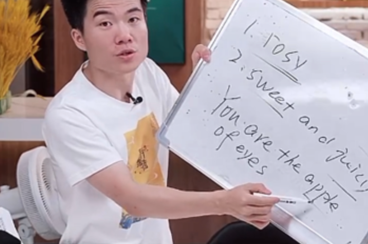 Dong explaining “you are the apple of my eye” when selling fruit